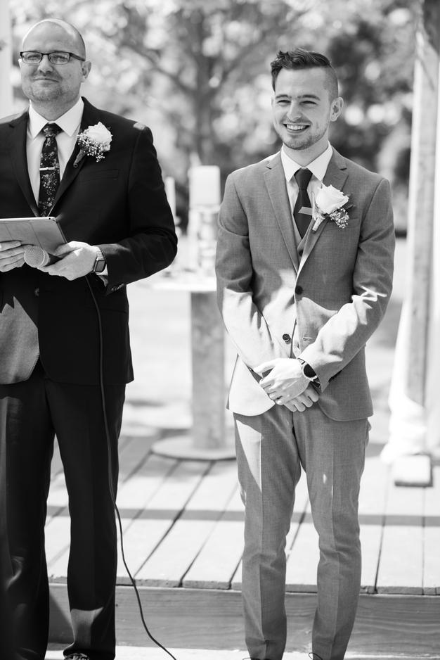 Groom and efficient anticipating bride coming down aisle
