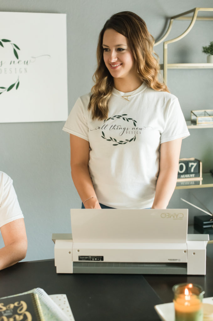 Co-owner of All Things New Design at her vinyl machine for the tee shirt aspect of their business informal portrait