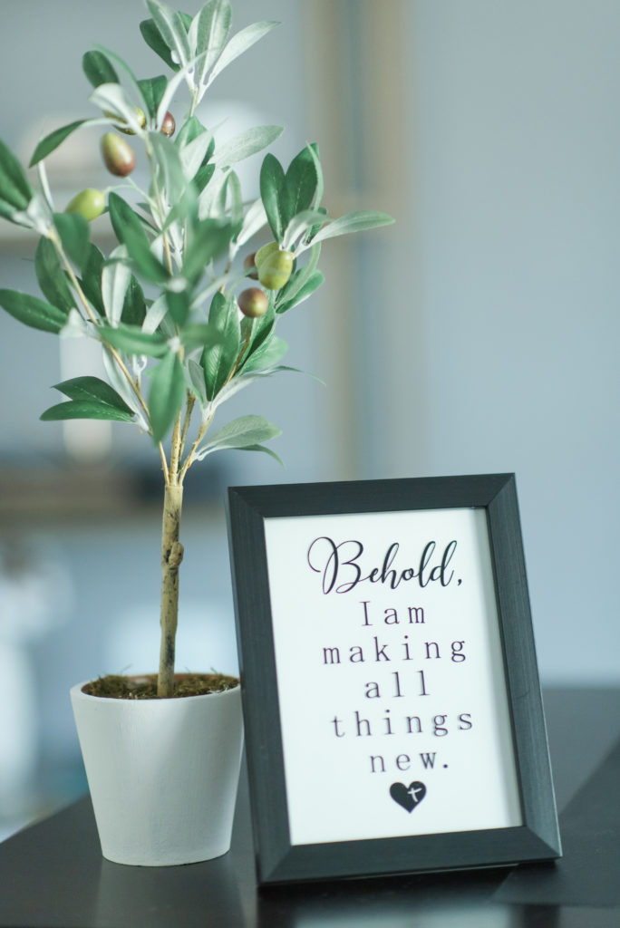 Key verse framed for All Things New Design in front of an olive branch - details for business branding photo session