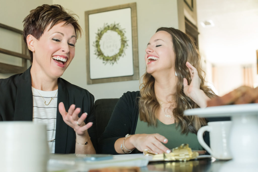 Business owner moms sharing a laugh at their personal branding photo shoot