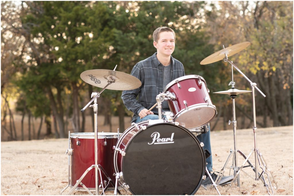 senior guy posing at drum set for senior pictures