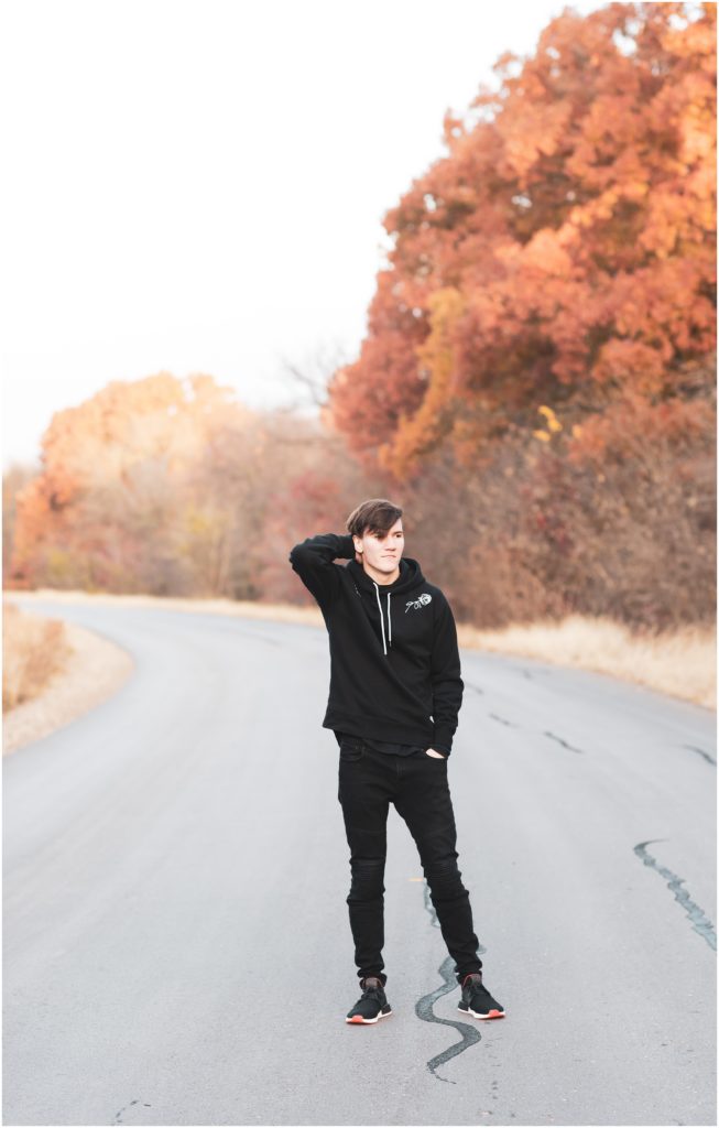 Texas fall senior session guy wearing black jeans in street