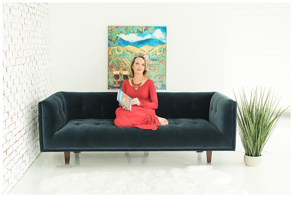 Austin business woman seated on couch with book