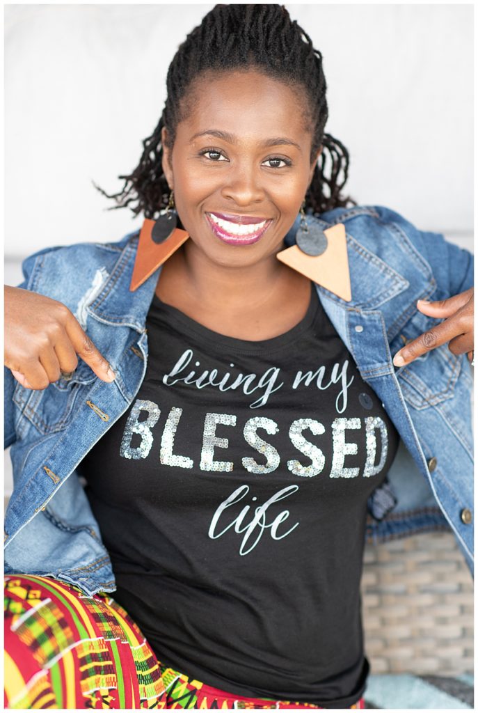 smiling woman with blessed shirt and jean jacket