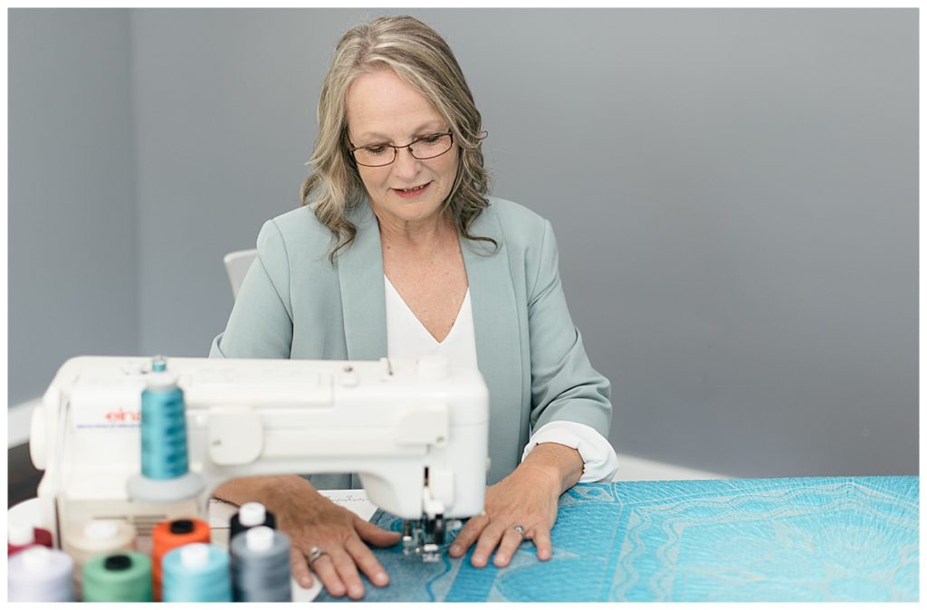 woman sewing quilt