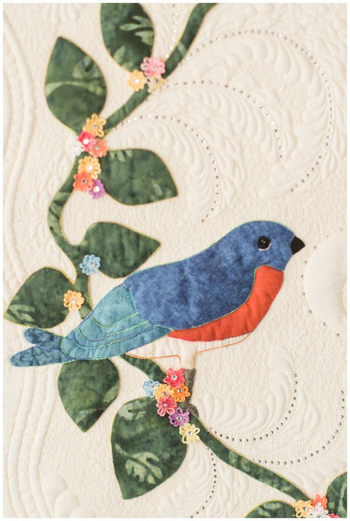 bluebird on green leaves on quilt