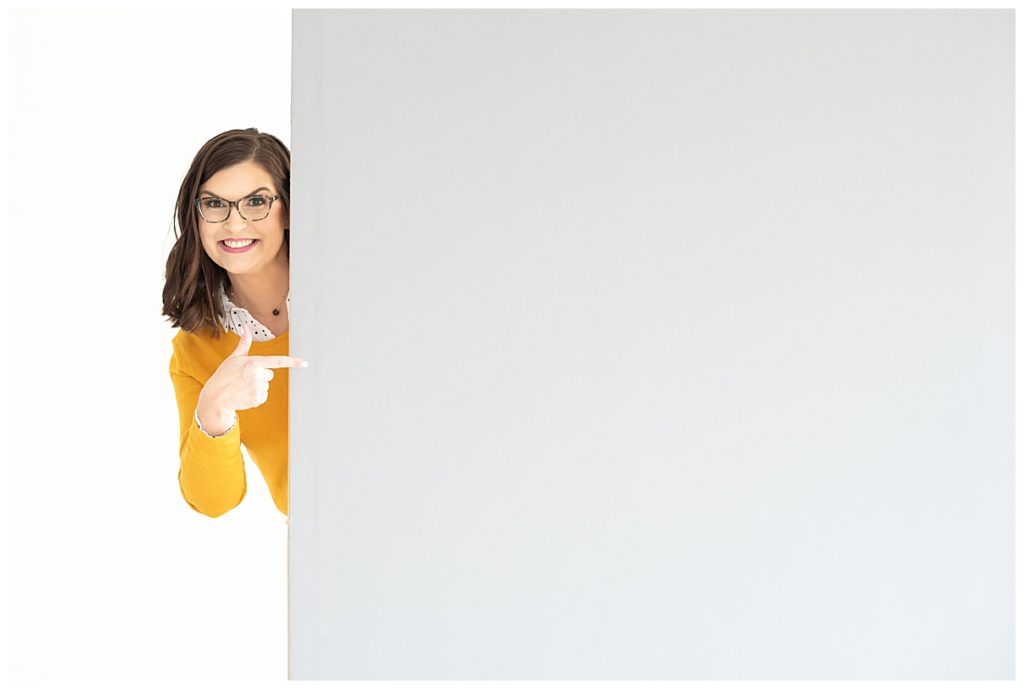 woman pointing to blank board