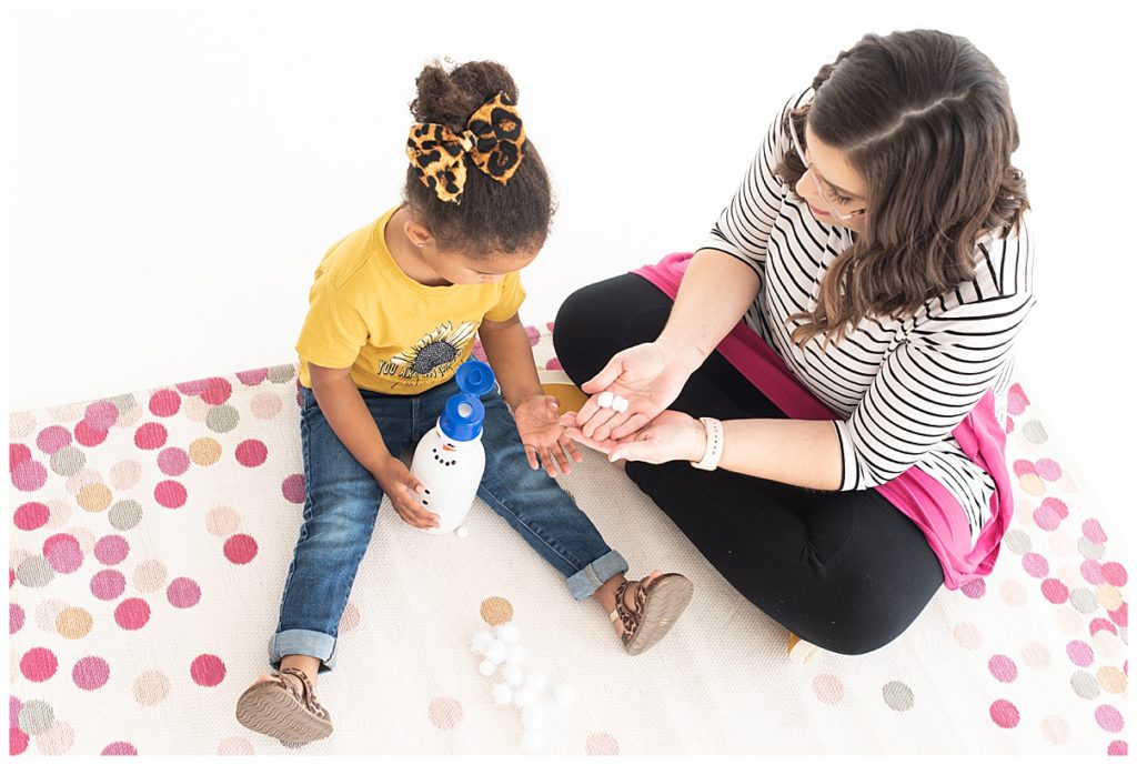 speech therapist on pink rug with preschooler